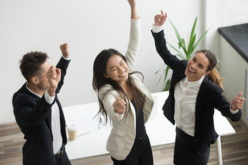 Employees cheering up after office relocation